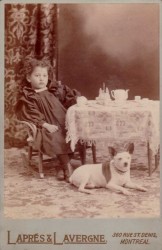 Antique photo of a girl, a dog, a tea party