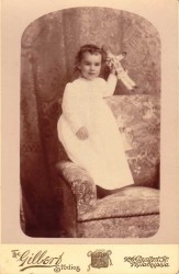 Antique photo of a girl and doll